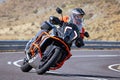 motorcyclist riding on his motorcycle on the road taking a sharp curve Royalty Free Stock Photo