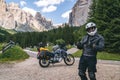 Motorcyclist man standing with adventure motorbike on the mountain road, beautiful summer view, danger road in mountains, freedom Royalty Free Stock Photo