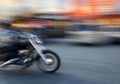 Motorcyclist in motion going down the street