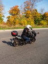 Woman biker on a black motorcycle in traffic Royalty Free Stock Photo