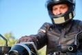 Motorcyclist out of focus using smartphone on motorcycle