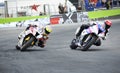 Motorcyclist overtaking another one on a bend during motorcycle racing