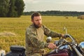 Motorcyclist racing his motorcycle down straight country road going a high speed at sunset Royalty Free Stock Photo