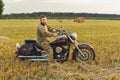 Motorcyclist racing his motorcycle down straight country road going a high speed at sunset Royalty Free Stock Photo