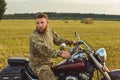 Motorcyclist racing his motorcycle down straight country road going a high speed at sunset Royalty Free Stock Photo