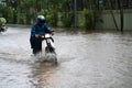 A motorcyclist rides along a flooded street in Hanoi city, Vietnam