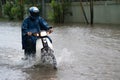 A motorcyclist rides along a flooded street in Hanoi city, Vietnam