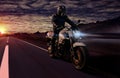 Motorcycle at night riding on country road Royalty Free Stock Photo