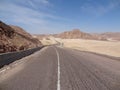 A motorcyclist rides on a mountain road Royalty Free Stock Photo