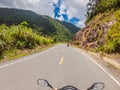 Motorcyclist rides on a serpentine road in cloudy weather. Vietnam, Dalat