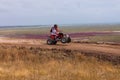 Motorcyclist rides on a wild hills. Motocross bike on beautiful rural landscape witj cloudy sky background,motorcycle 4K Royalty Free Stock Photo