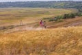 Motorcyclist rides on a wild hills. Motocross bike on beautiful rural landscape witj cloudy sky background,motorcycle 4K Royalty Free Stock Photo