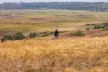 Motorcyclist rides on a wild hills. Motocross bike on beautiful rural landscape witj cloudy sky background,motorcycle 4K Royalty Free Stock Photo