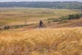 Motorcyclist rides on a wild hills. Motocross bike on beautiful rural landscape witj cloudy sky background,motorcycle 4K Royalty Free Stock Photo