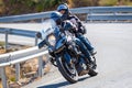 motorcyclist riding on his motorcycle on the road taking a sharp curve Royalty Free Stock Photo