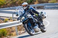 motorcyclist riding on his motorcycle on the road taking a sharp curve Royalty Free Stock Photo