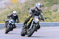 motorcyclist riding on his motorcycle on the road taking a sharp curve Royalty Free Stock Photo