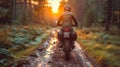 Motorcyclist riding on a muddy forest road at sunset