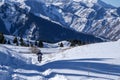 Motorcyclist is running enduro motorbike on snow trail in mountains.