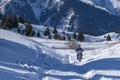 Motorcyclist is running enduro motorbike on snow trail in mountains.