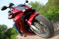 Motorcyclist standing on country road, bottom view