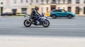 Motorcyclist on the Suzuki GSX motorcycle driving fast on the city street. Exceeding the speed limit is not allowed Royalty Free Stock Photo