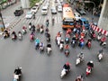 Motorcyclists and cars wait at a junction during rush hour Royalty Free Stock Photo