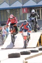 Motorcyclists on track juming on a ramp