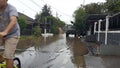 20 February 2021, Motorcyle acrossing Flooding small street at Condet East Jakarta, Indonesia