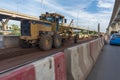 Motorgrader working at Construction site of sky train redline Ba Royalty Free Stock Photo