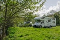 Motorhome campers parked in a camp in early spring