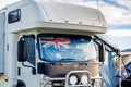 Motorhome campervan with flag of Australia on the windscreen at the campground. Australian camping and travel lifestyle concept