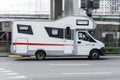 Motorhome, Caravan car for trip or vacation, driving on the city street. Camper based on Gazelle NEXT in motion on the urban road