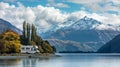 A motorhome cruises along the lakes edge, offering panoramic views of the encompassing mountains