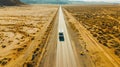 Motorhome driving along an empty road through the desert, aerial view of the scenic journey