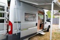 Motorhome gray RV campervan parked open door with awning