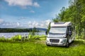 Motorhome on river with camping table