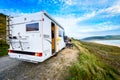 Motorhome RV and campervan are parked on a beach Royalty Free Stock Photo