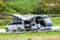 Motorhome RV and campervan are parked on a beach