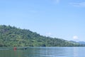A motorized boat is seen crossing the hills of Lake Aranio, South Borneo, Indonesia.