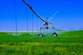 Motorized watering system in use to irrigate crops. Royalty Free Stock Photo
