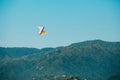 Motorized Hang Glider Flying Over Mountain Hills In Blue Clear Sunny Sky Royalty Free Stock Photo