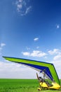 Motorized hang glider over green grass Royalty Free Stock Photo