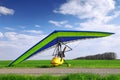 Motorized hang glider over green grass Royalty Free Stock Photo