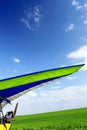 Motorized hang glider over green grass Royalty Free Stock Photo