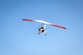 Motorized hang glider soaring in the blue sky Royalty Free Stock Photo