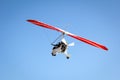 Motorized hang glider soaring in the blue sky Royalty Free Stock Photo