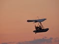 Motorized hang glider at sunset