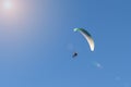 Motorized paraglider flies in the blue sky, extreme sports Royalty Free Stock Photo