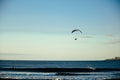 A motorized paraglider flies over the sea, the ocean. Beach recreation. Summer and hobbies Royalty Free Stock Photo